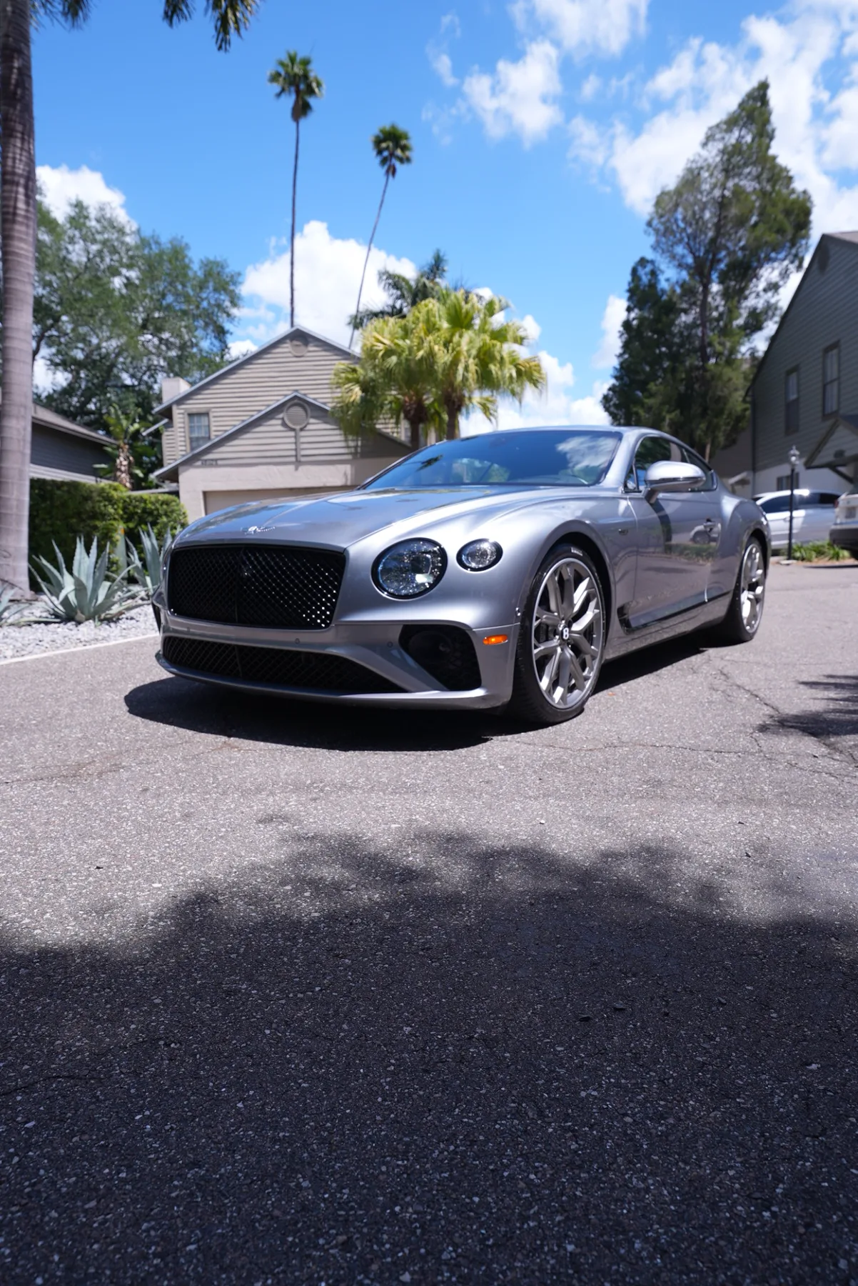 Silver Bentley Continental GT with a reflective finish