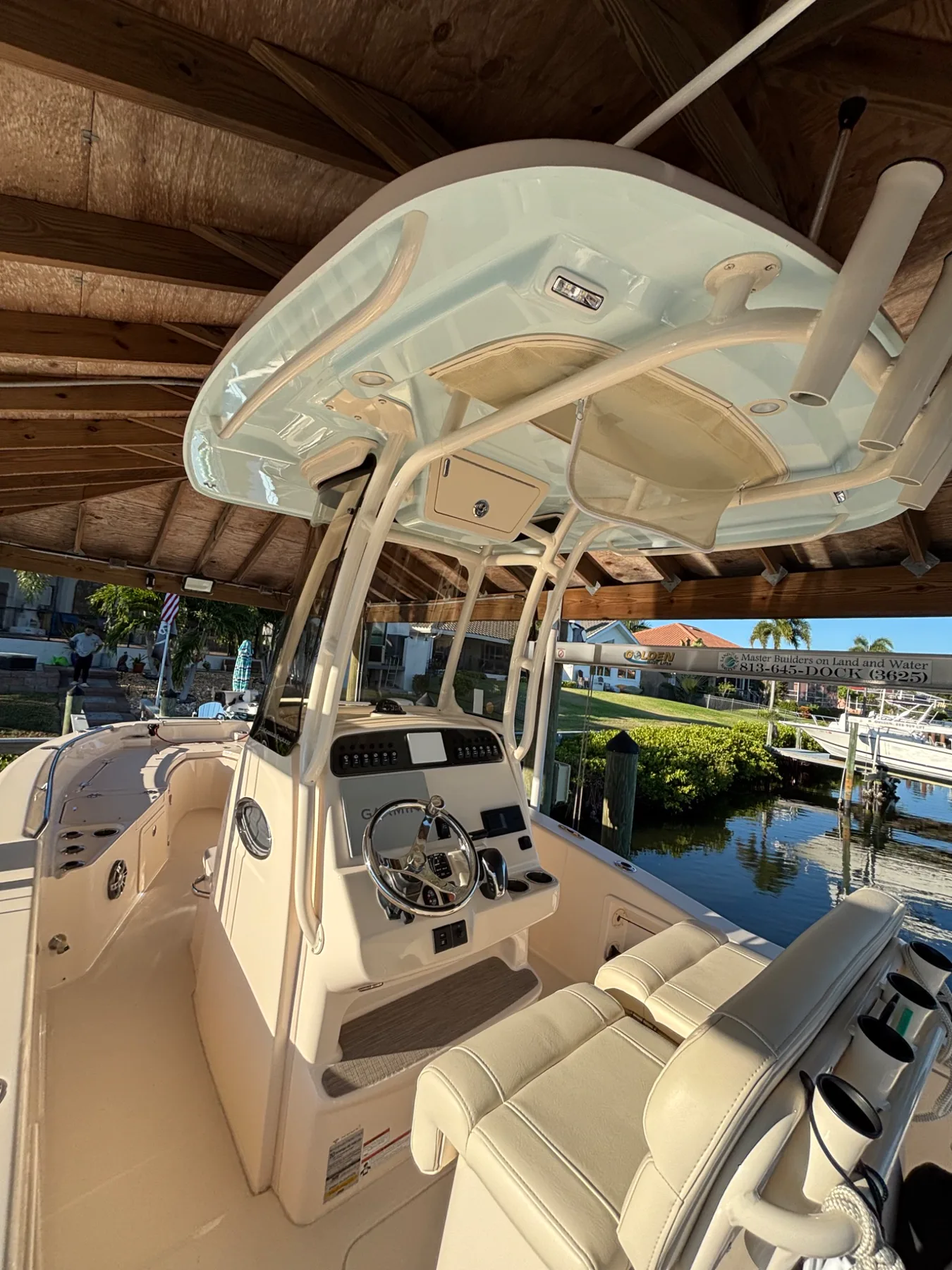 Detailed boat helm and seating under a covered dock