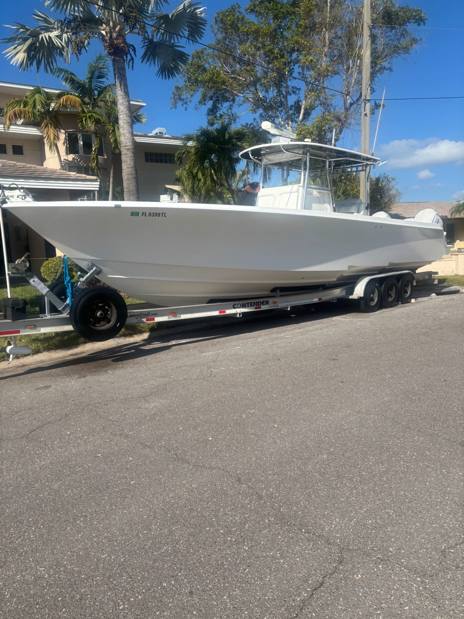 Full white center-console boat presented on its trailer