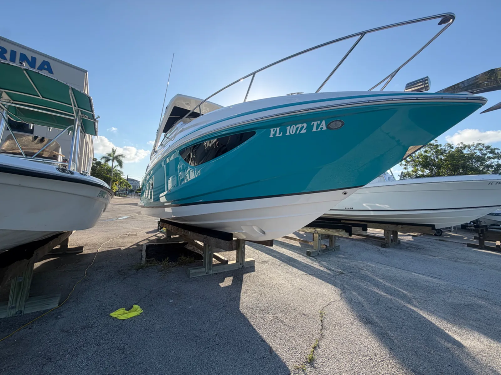 Glossy blue-and-white boat presented at a boatyard