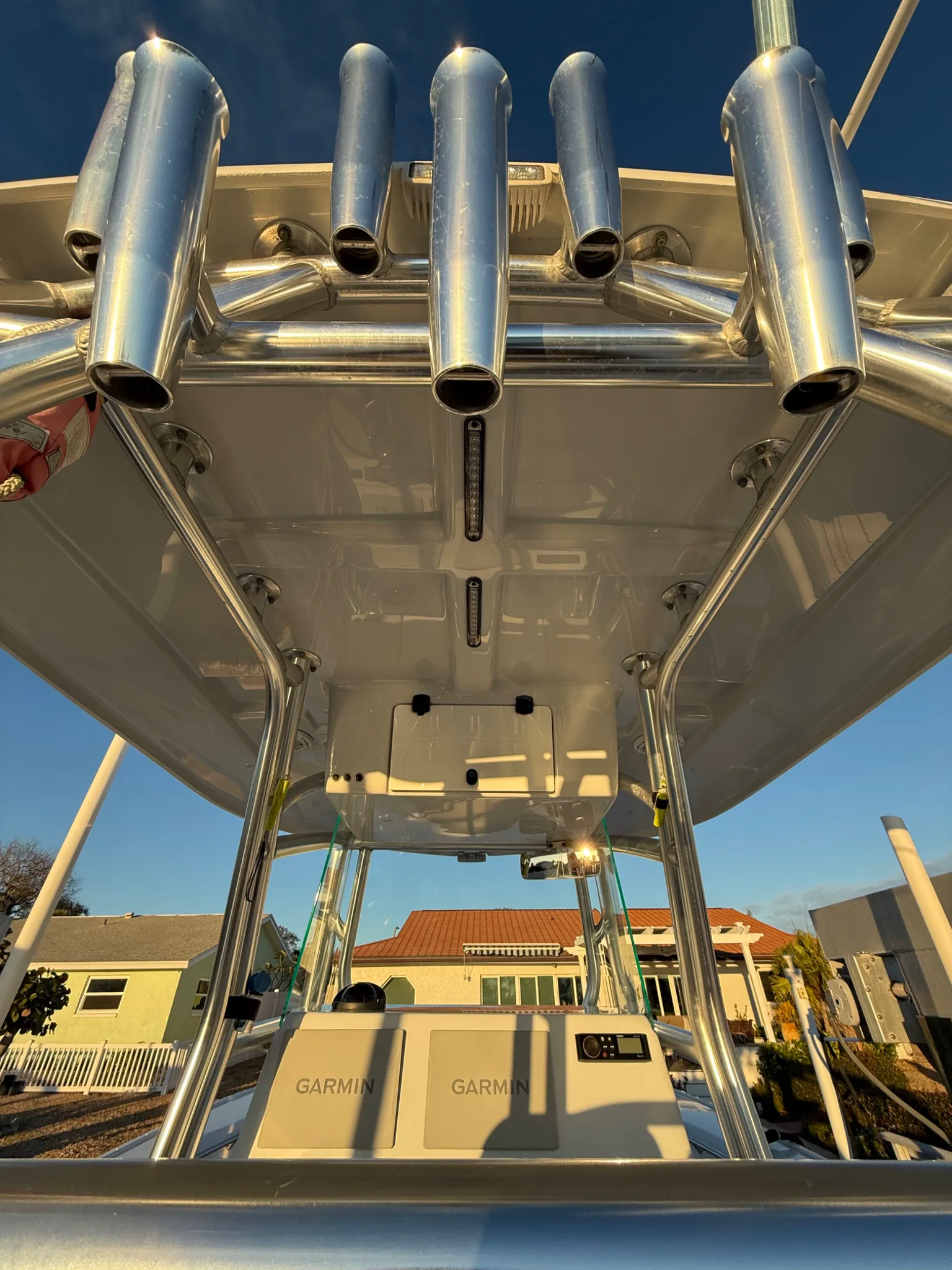 Polished rod holders and clean hardtop surfaces in warm waterfront light