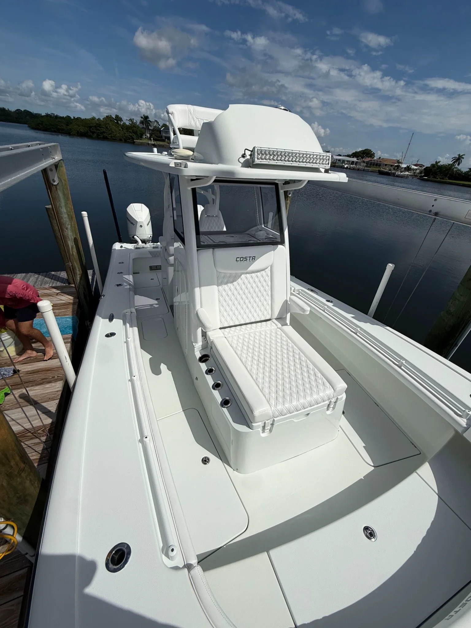 Clean white Cobia center-console deck, helm seat, and hardtop