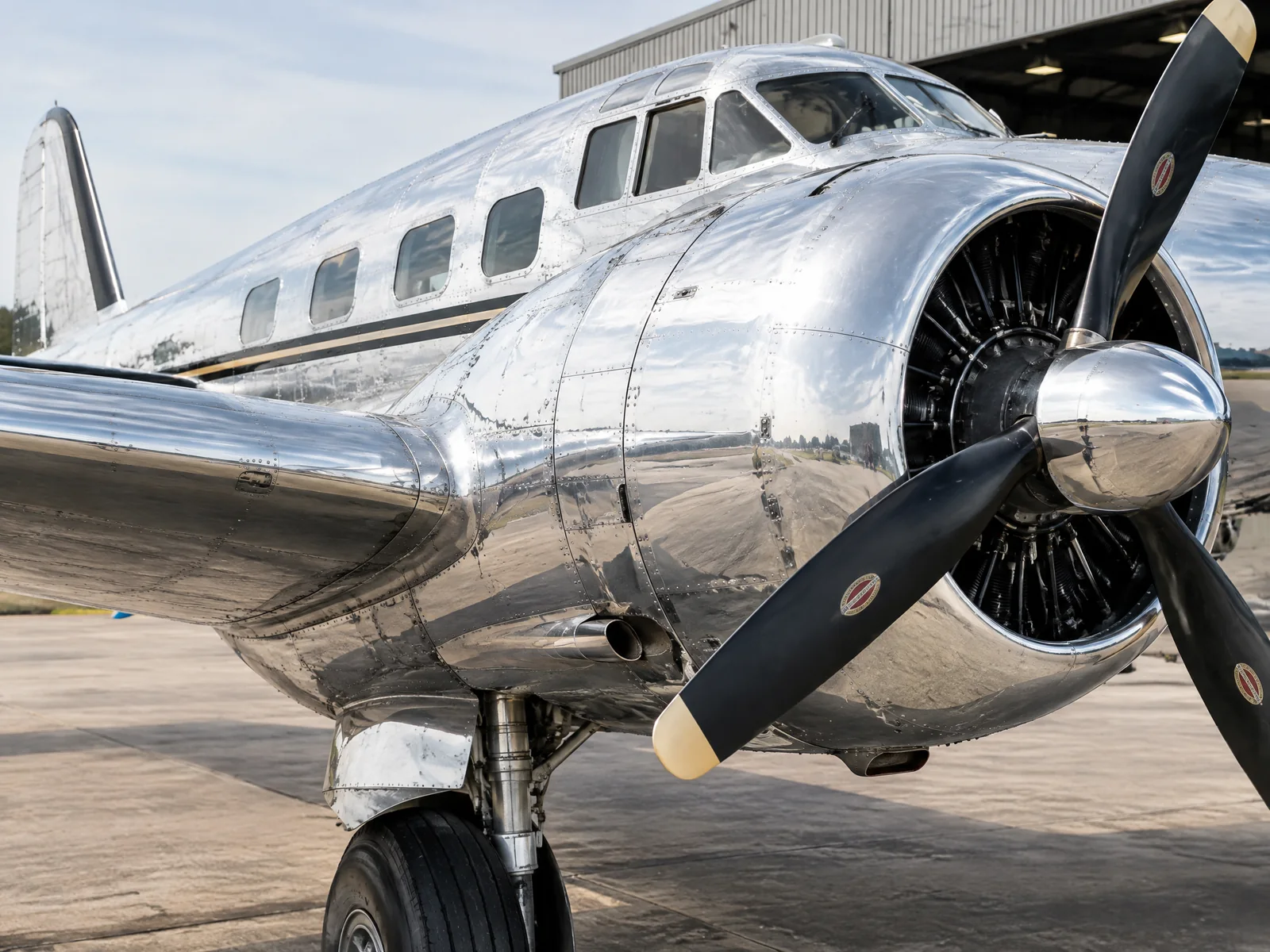 AI-generated illustration of polished aluminum and a radial engine on a vintage twin-engine aircraft; not a completed restoration