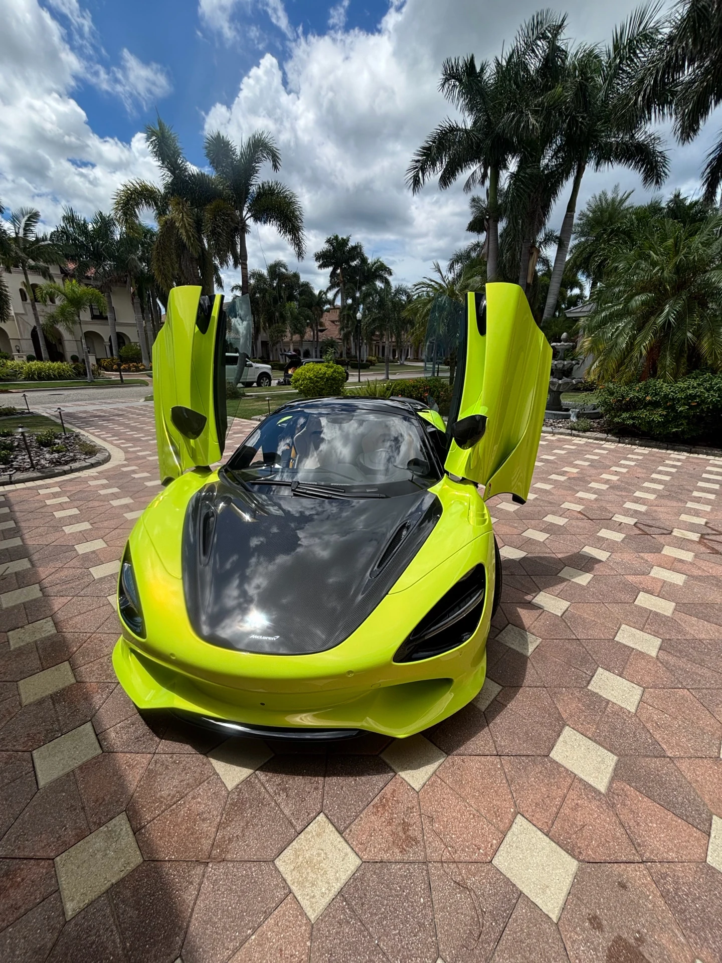 Lime green McLaren with both doors raised at a Tampa Bay residence