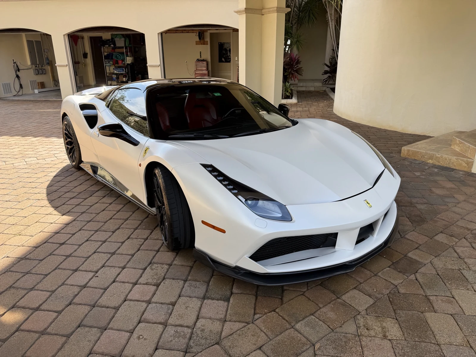 White Ferrari photographed from the front three-quarter angle after Mighty Munch automotive work