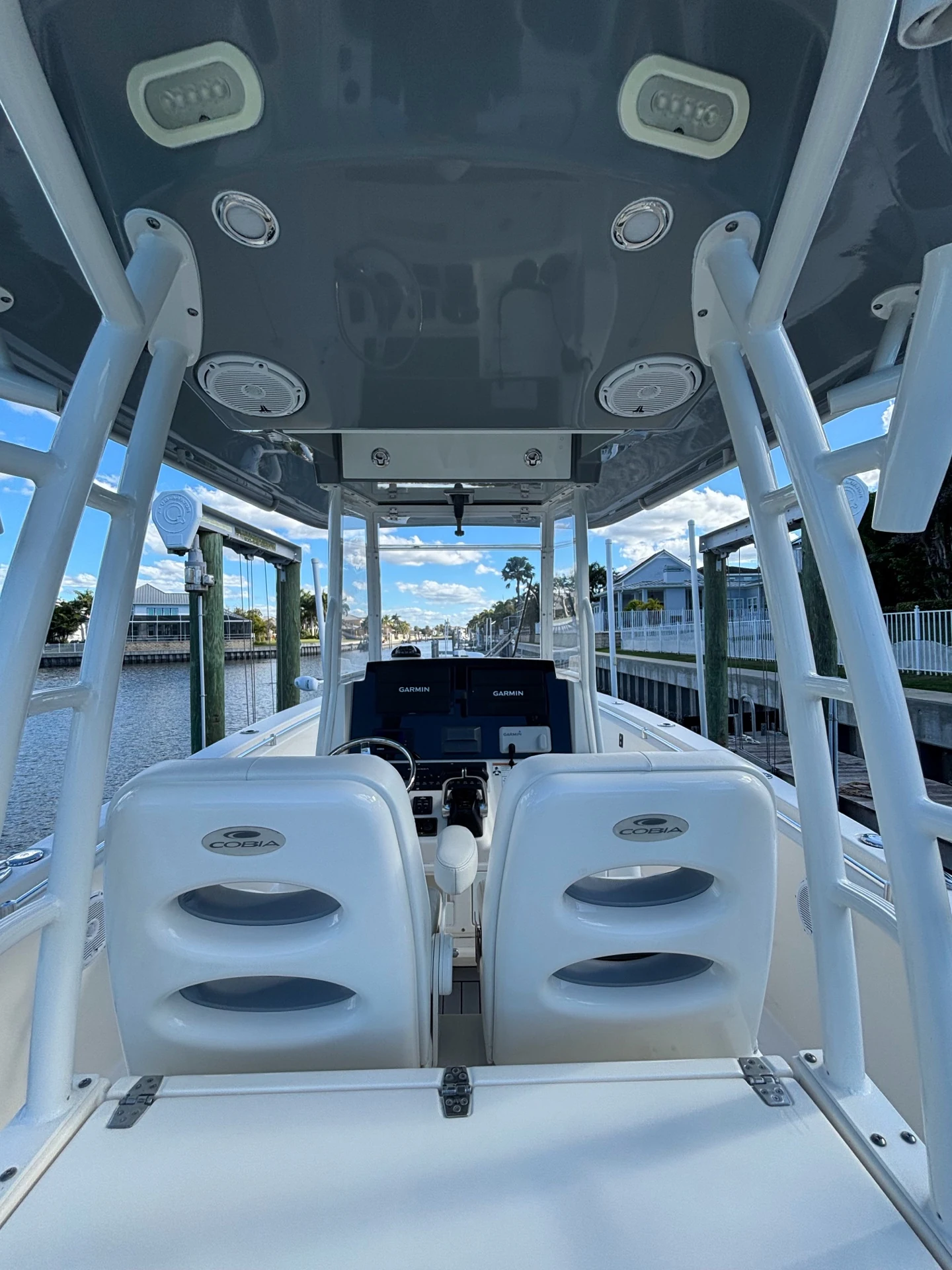 Cobia center-console cockpit with clear windshield and glossy hardtop underside