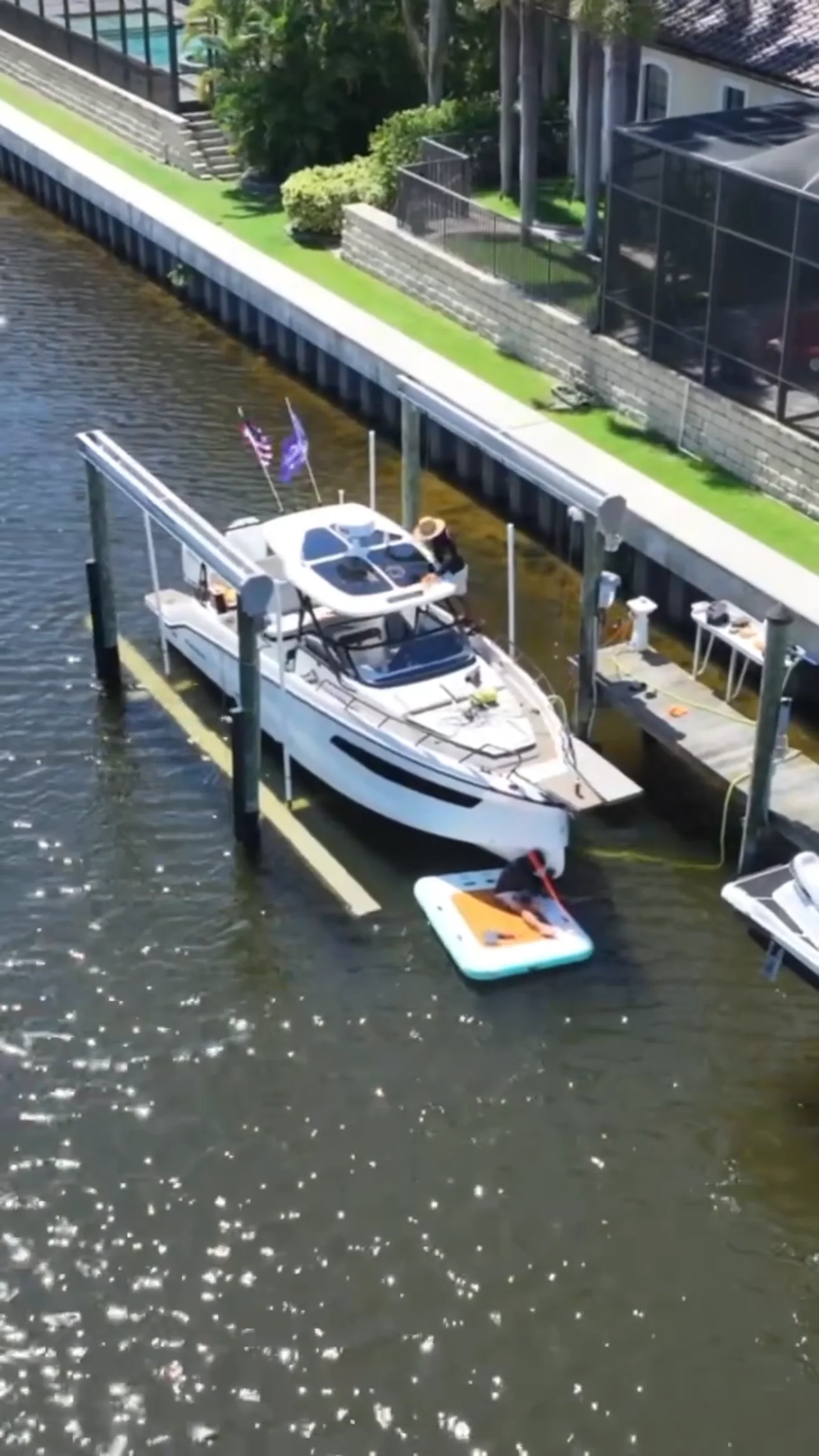 White boat kept at a residential waterfront dock