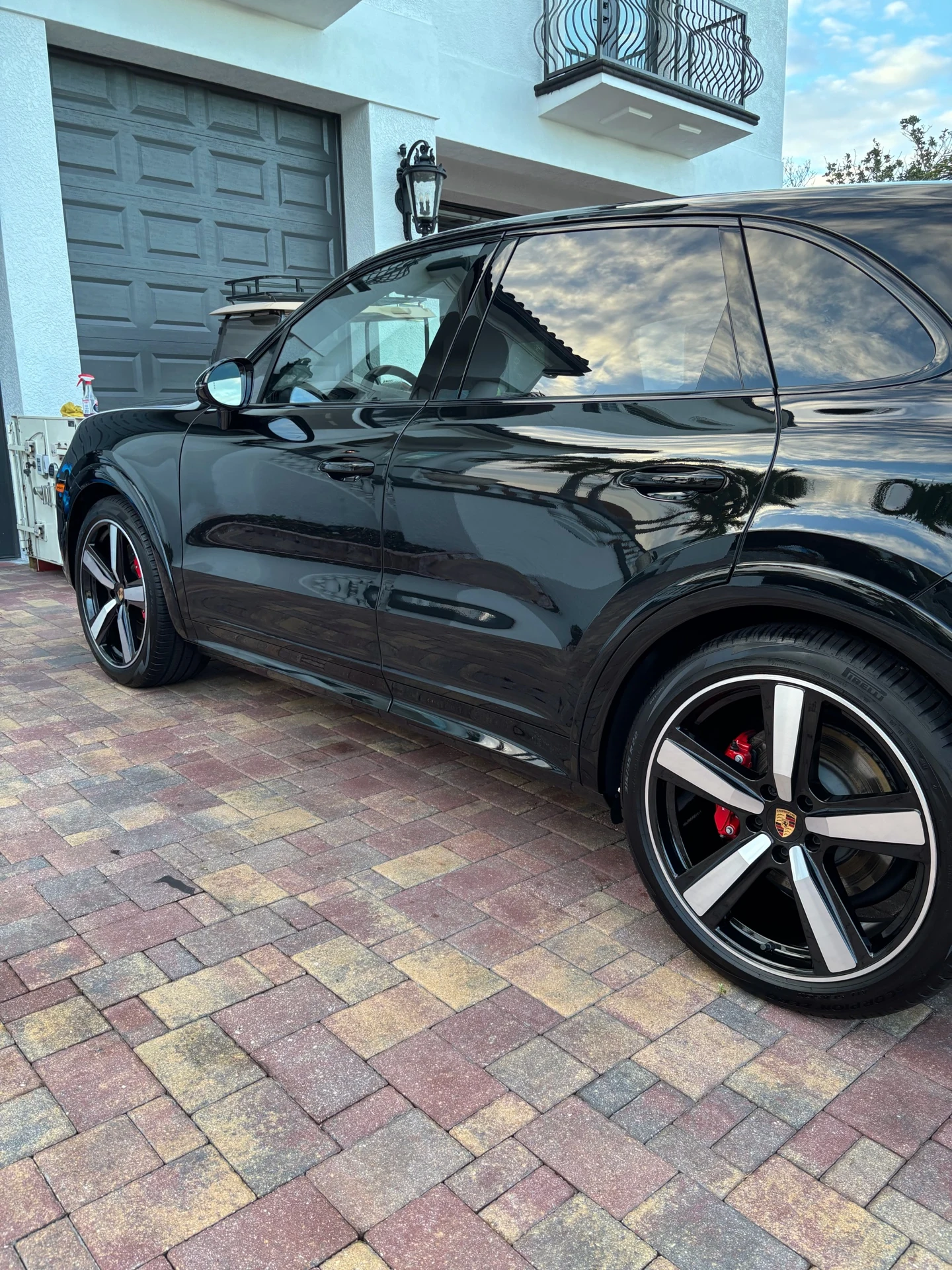 Black Porsche SUV side profile with reflective paint and wheel detail